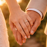 Anniversary wishes for husband — couple holding hands with wedding rings